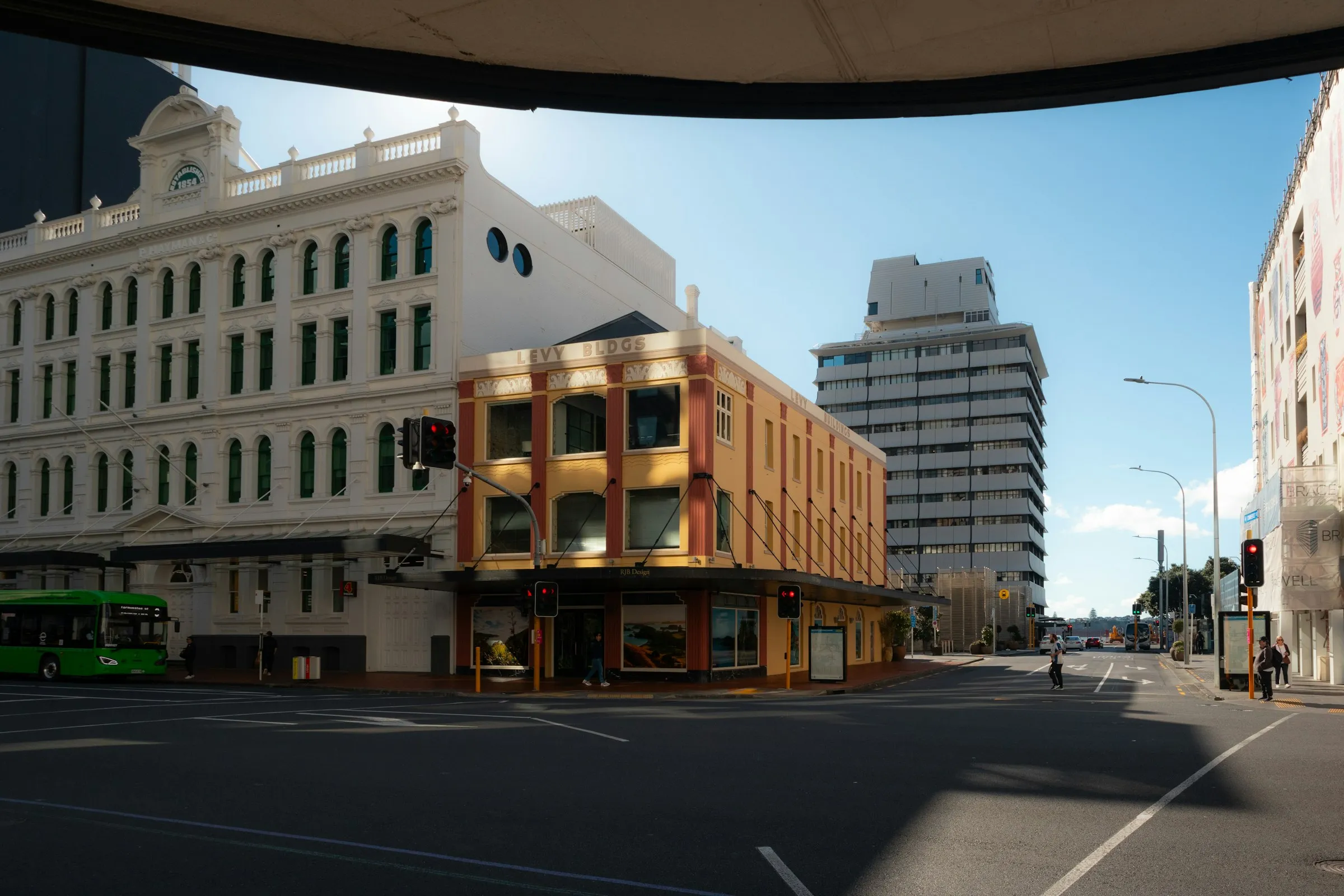A sunny Auckland street lined with commercial buildings