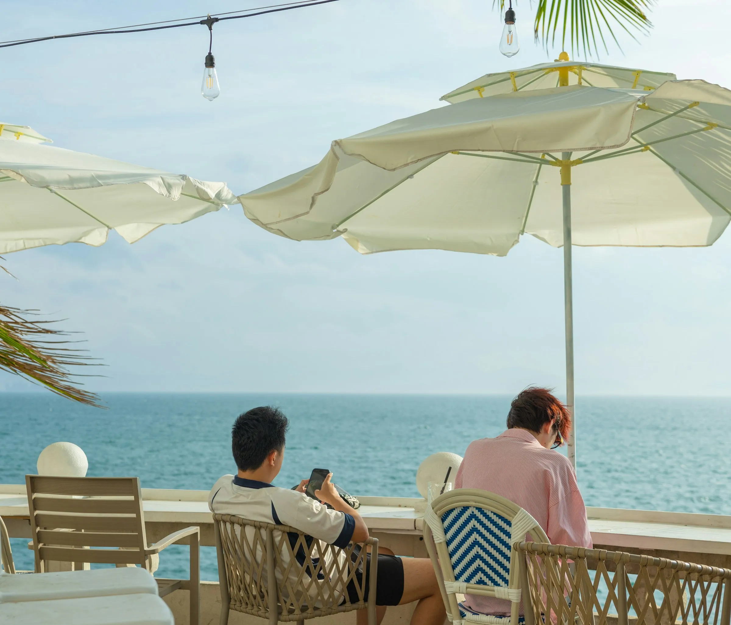 A couple relaxing at a seaside café on a sunny day